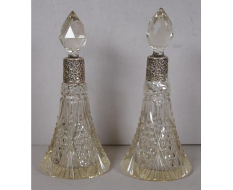 Two cut glass perfume bottles with sterling silver collars, English hallmark rubbed, 19.5cm high