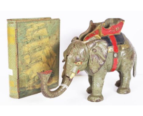 Vintage cast iron elephant form money box with mechanism to raise the elephant's trunk and place coin into the money box, (he