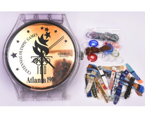 Swatch watches. A 12 inch display clock in the form of a watch celebrating the 1996 Atlanta Olympic Games. Together with 21x 