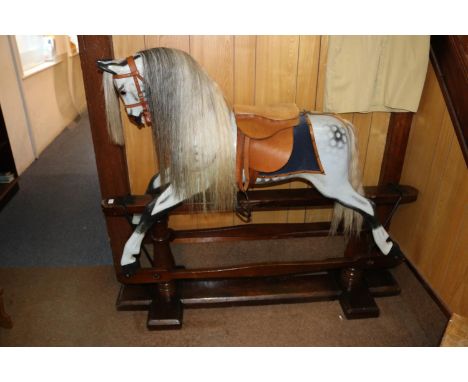 A traditional English hand carved children's wooden rocking horse by F.H. Ayres. Supplied by Stevenson Brothers in 1995, this
