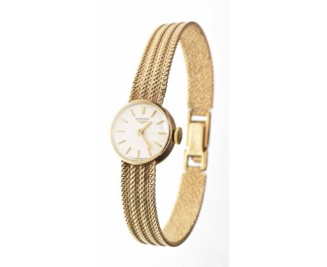 Longines: A Ladies 9ct gold manual wind wristwatch
The circular signed face, with gold baton markers, to an integrated bracel