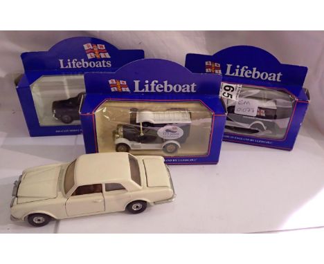 Three boxed RNLI die-cast car models, an RNLI official naming of Atlantic 75 life boat and a die-cast Rolls Royce model. P&am