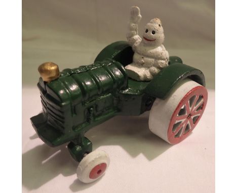 Cast iron Michelin Man on a tractor, H: 80 mm. P&amp;P Group 1 (£14+VAT for the first lot and £1+VAT for subsequent lots) 