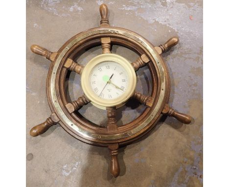 Brass bound wall clock within a ships wheel. Battery powered, does work with battery, scuffs to wood on parts of the wheel an