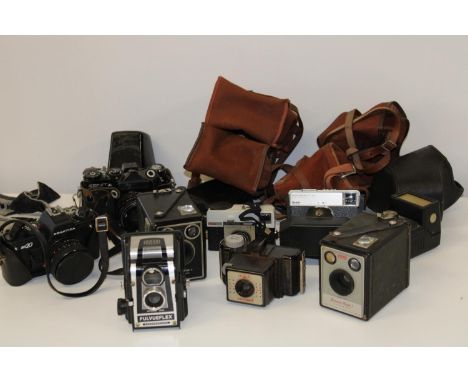 A box full of assorted vintage cameras 