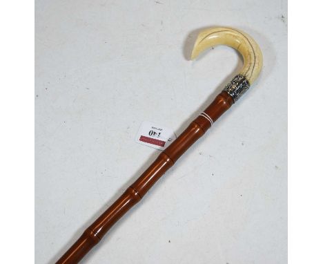 A 19th centruy bamboo walking stick with ivory handle and silver collar, 85cm