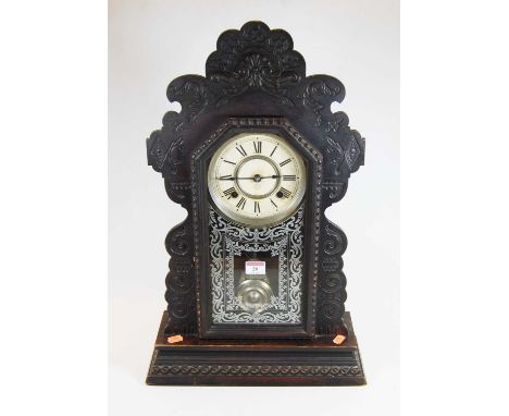 An early 20th century American gingerbread mantel clock, the painted dial showing Roman numerals, eight day movement, height 