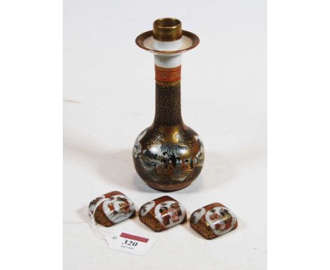 A Japanese Meiji period kutani candlestick having slender neck to bulbous lower body decorated with reserves of figures amid 