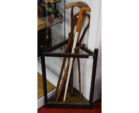 An oak corner stick stand together with sundry walking canes
