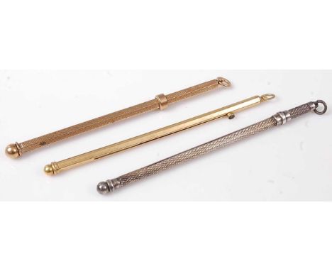 An engine turned 9ct gold swizzle stick, 5.3g; together with a gilt metal example; and an engine turned silver example (3)