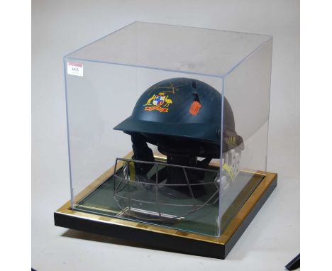 An Australian cricket helmet with plaque Australian Helmet signed by The Legendary Shane Warne with signature to top in gold 