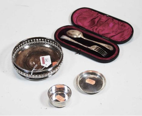 A modern silver bottle coaster, of squat circular form, with pierced decoration; together with a circa 1900 silver christenin