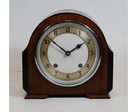 A 1930s walnut cased mantel clock, the silvered chapter ring showing Arabic numerals, eight day movement, height 20cm