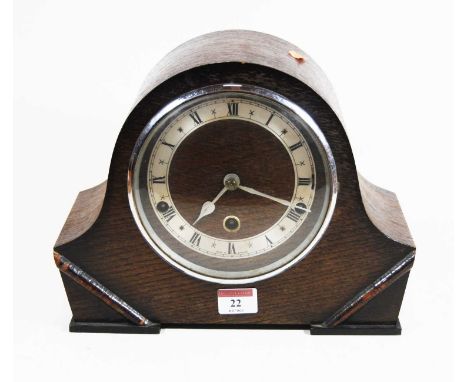 A 1930s oak cased mantel clock, the silvered chapter ring showing Roman numerals, eight day movement with Westminster chimes,
