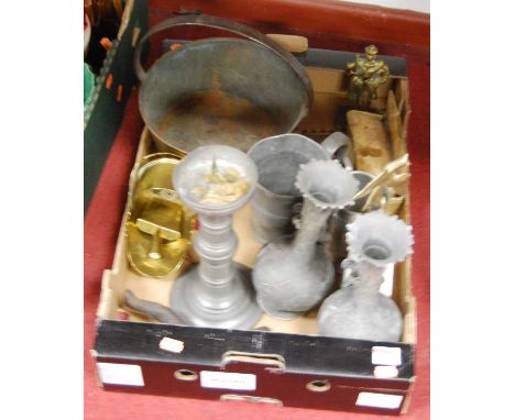 A box containing a collection of metal ware to include a pewter candlestick and a tankard