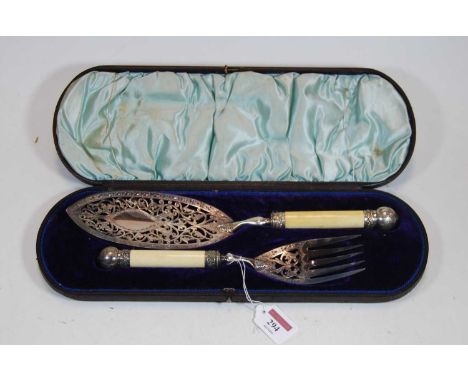 A pair of late Victorian silver plated fish servers, the slice having oval blade with pierced and foliate decoration, the for