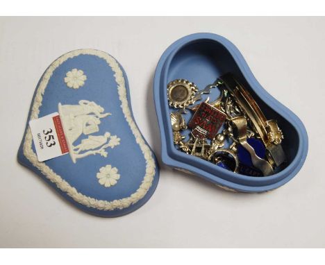 A Wedgwood blue jasperware heart shaped trinket jar and cover containing various white metal charms and Civil Defence badge e