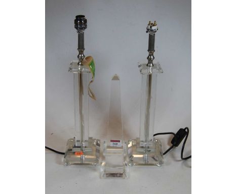 A contemporary glass obelisk, height 31cm, together with a similar pair of table lamps, 44cm high eachCondition report: Each 