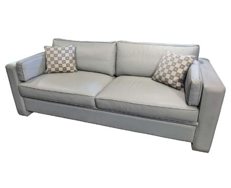 A HUGUES CHEVALIER 3-PERSON PULLOUT SECTIONAL SOFA two sections, light grey leather upholstery, sold along with two embroider