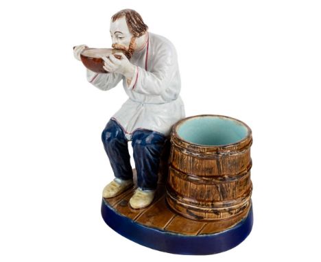 A RUSSIAN PORCELAIN FIGURE OF A PEASANT DRINKING FROM A KOVSH, KUZNETSOV PORCELAIN FACTORY, TVER, LATE 19TH CENTURY realistic