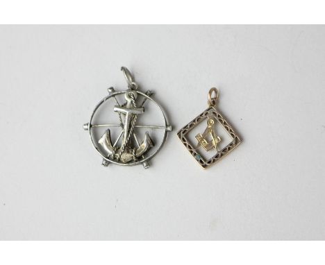 A 9ct gold Masonic pendant, pierced design with compass and set square, 0.9g, and a white metal nautical pendant of an anchor