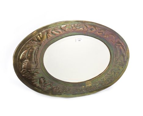 ARTS &amp; CRAFTS STYLE OVAL WALL MIRROR, the bevelled mirror within an oval frame decorated with seaside motifs including sh