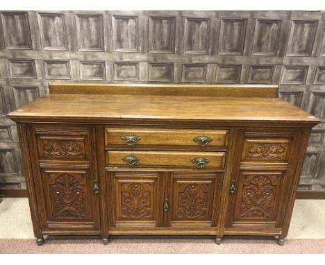 VICTORIAN OAK SIDEBOARD, (lacking mirror back), the two central drawers with cupboard below enclosed by two floral carved pan