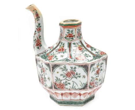 A Chinese Porcelain Ewer, Kangxi, of fluted hexagonal form with scroll spout, painted in famille verte enamels with panels of