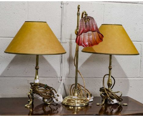 An early 20th century brass rise and fall lamp with cranberry tinted shade, 51cm 