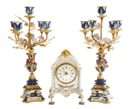 A 20th century mantel timepiece in Dresden porcelain case, together with a pair of Sevres style five-light candelabra, with a