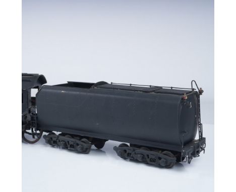A detailed vintage model train locomotive and tender, featuring intricate craftsmanship and functional components. The locomo