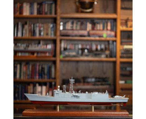 Presenting a highly detailed handcrafted scale model of a modern-day frigate naval ship. This remarkable piece showcases intr