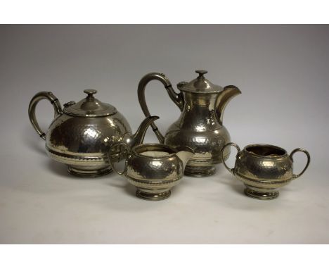 A James Dixon planished pewter tea service, including teapot, hot water jug, cream jug and sugar bowl (4)