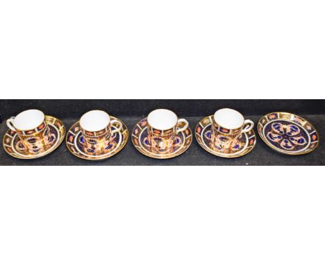 A set of four Royal Crown Derby 1128 pattern coffee cup and saucers; a similar saucer