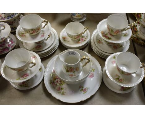 A Limoges part tea service, decorated with summer flowers on a white ground
