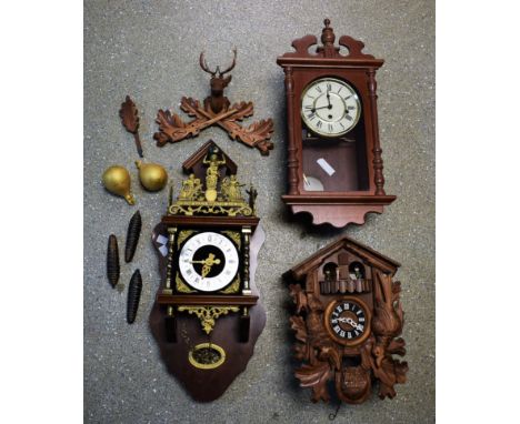 A Franz Hermle Atlas wall clock, mahogany case, gilt metal decoration with finial modelled as Atlas and globe, 2 tear drop we