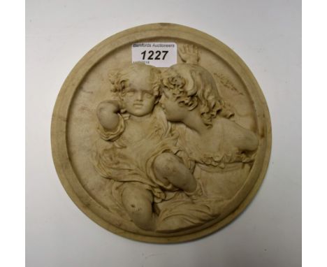 A roundel of two children, Roman style intaglio to reverse, 17.8cm diameter
