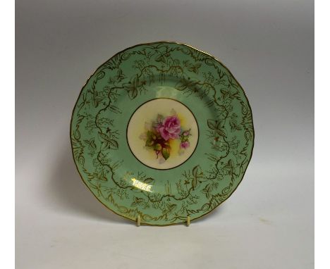 A Royal Worcester circular shaped plate, painted by M Millea, signed with pink cabbage roses, on a light green ground, applie