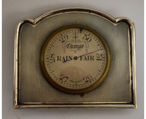 An Art Deco style silver coloured metal thermometer/barometer