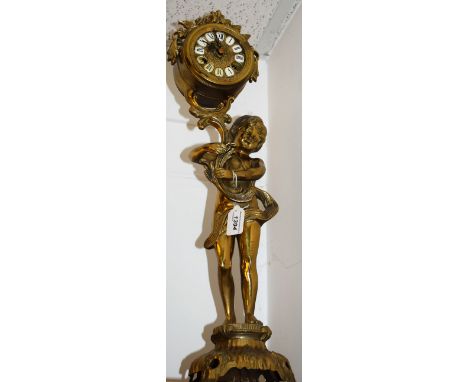 A Rococo style brass figural clock modelled as a scantily clad putto, 62cm high