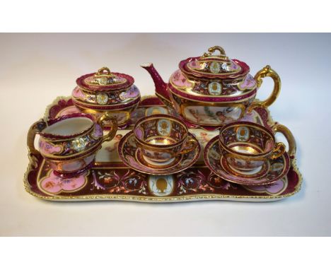 A Vienna porcelain tete a tete comprising teapot, cream jug, sucrier, cups and saucers on conforming tray