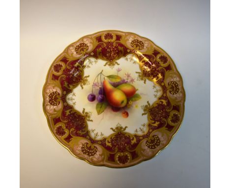 A Royal Worcester shaped circular plate, painted by Albert Shuck, signed, with ripe pears  and blueberries, within fancy gilt