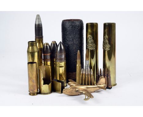 An assortment of trench art and shells, including a pair of 1941 Royal Army Ordnance Corps shells, a large shell with fuse, 3