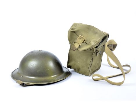 A Brodie tin helmet, in different shades of green, complete with liner and chin strap, together with No. 4 III gas mask, mark