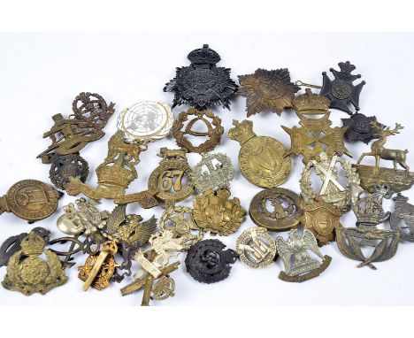 A selection of 20th Century cap badges, including Coldstream Guards, London Rifle Brigade, Royal Malta Militia, The Queen's O