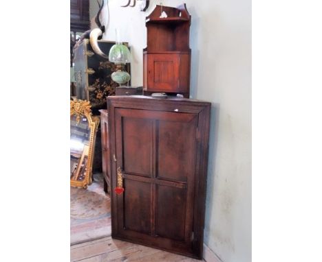 A 19th century oak corner cupboard, 70cm wide, together with a 20th century wall mounting corner display shelf and cupboard, 