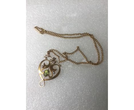 A 9ct gold peridot and seed pearl necklace of Art Nouveau design, to a 15ct gold chain.