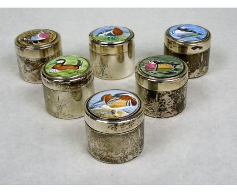 A set of six silver cylindrical pill boxes, each having hand painted enamel cover, depicting wild fowl, initialled PS.