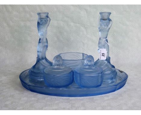 An early 20th century French blue glass dressing table set, comprising: oval tray, a pair of candlesticks, a pair of covered 