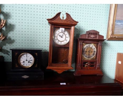 A Victorian slate mantle clock, the circular enamel dial bearing Roman numerals, together with two further clocks.